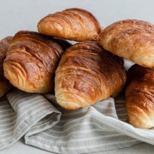 Bakers toms fresh croissants, baked daily